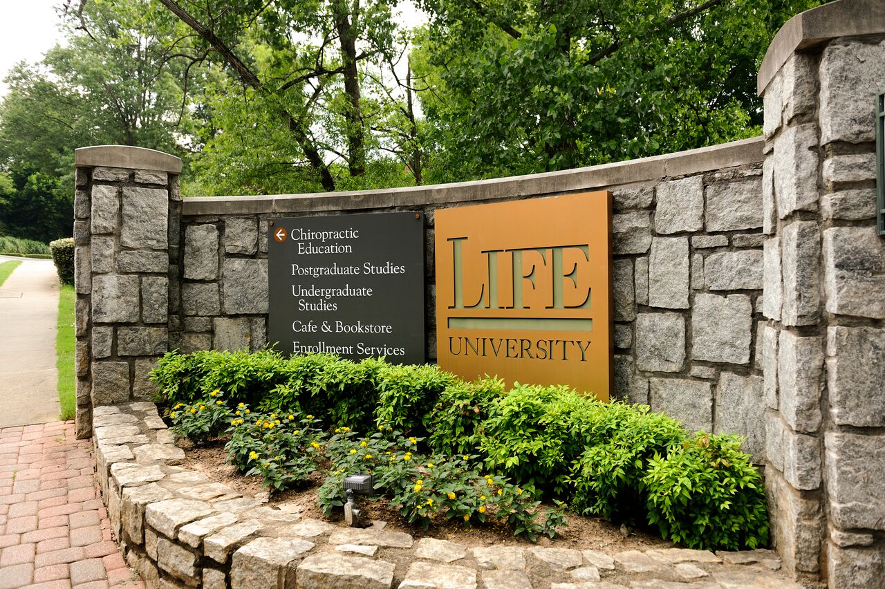 Image of Life University Sign on above a raised flowerbed